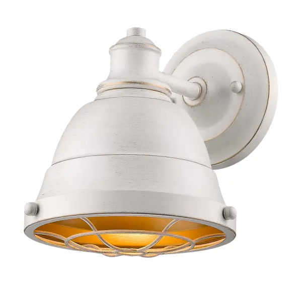 The Bartlett vanity light combines industrial style with traditional elegance through its hand-brushed French White finish with gold undertones. Damp-rated for bathroom use, this compact fixture delivers rustic charm in a small footprint.