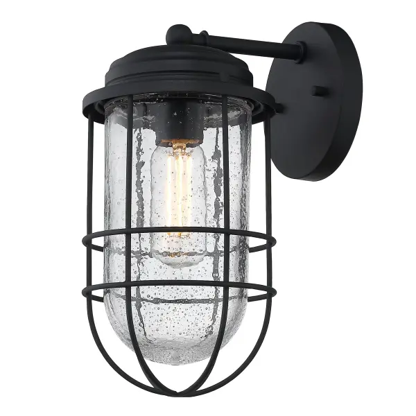 The Seaport outdoor wall sconce brings vintage coastal elegance with its seeded glass shade and matte natural black finish. Wet location rated for direct weather exposure, it's perfect for entryways, patios, and garage doors.