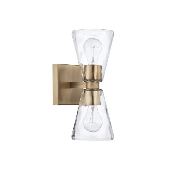 The Lyra 2-Light Sconce combines timeless brass warmth with a compact profile ideal for bathrooms and hallways. Its transitional design bridges traditional and modern aesthetics effortlessly.