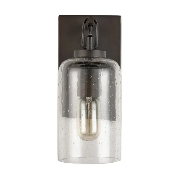 The Wilton wall sconce brings traditional elegance to any space with its compact 5-inch width and warm Old Bronze finish. Perfect for hallways, bathrooms, and bedrooms where classic styling meets functional lighting.