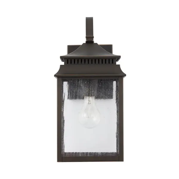 The Sutter Creek wall lantern brings traditional charm to outdoor spaces with its compact 7-inch width and warm oiled bronze finish. Perfect for flanking doorways or illuminating pathways with classic style.