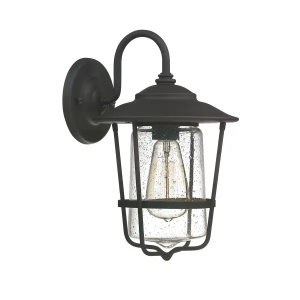 The Creekside wall lantern brings traditional charm to outdoor spaces with its compact 8.25" profile and durable black finish. Perfect for flanking doorways or illuminating walkways with classic lantern styling.
