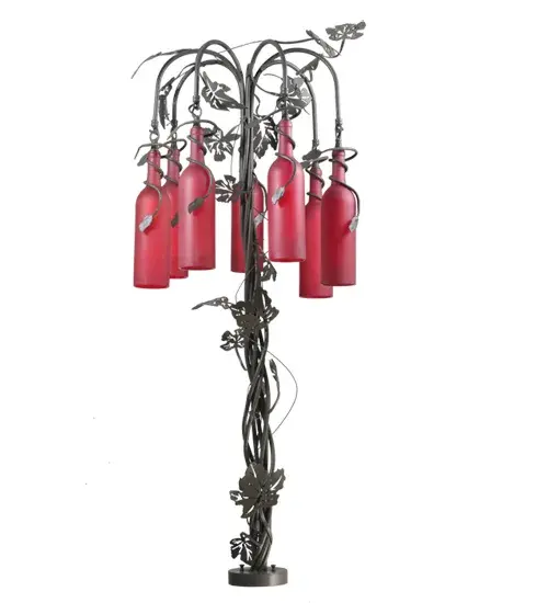 Capture the life of the party with the whimsical design of the Meyda Wine Bottle Table Lamp. Liven up a restaurant; club; or home with a table lamp that does so much more than deliver light; it adds personality and pizzazz. Seven Wine Bottles are featured in Frosted Red Glass and are suspended from Timeless Bronze finished arms; embraced by a table base with complementary metal leaf accents. Create a stunning design statement by directly mounting it to a J-Box and placing it on bars in homes; restaurants; hotels; pubs; nightclubs; and wineries. This lamp will be appreciated for its fine detail and charm by connoisseurs. This Tuscan Vineyard Red 7 Light Wine Bottle Table Lamp is included in our American-made; American-designed; handcrafted Wine Bottle Lighting Collection. The fixture is manufactured in Yorkville; New York. UL and cUL listed for dry and damp locations. Take your finest bottle of wine; and Meyda will transform it into an everlasting personalized fixture of light. Contact us for more information on custom wine bottle lighting fixtures and lamps. We can also create custom lighting with beer bottles; mason jars; milk bottles; and other glass containers and vessels. - alternate view