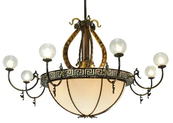 A dramatic theatrical lighting fixture that currently adorns the Traverse City, Michigan Opera House, our chandelier features a stunning Fleshtone Idalight shade trimmed with a dramatic Greek Key border design. Above the inverted dome shade is a striking, three-dimensional Golden finished Lyre with fanciful grape accents, and eight arms embracing hand-blown etched glass globes from France. Hardware is hand finished in Light Burnished Brass. Includes a canopy, 10 feet of chain and 12 feet of wire.Handcrafted in our 180,000 square foot manufacturing facility in Yorkville, New York. Shade colors, metal finishes and fixture sizes can be customized. Collection: Lyre Finish: Light Burnished Brass Tint Glass: Fleshtone Idalight Width: 96.00" Height: 84.00" Length: 96.00" Weight: 269.00 lb Number of Bulbs: 18 Maximum Wattage: 60.00 W Bulb Type: A19 Bulb Base: E26 Material: Steel Country of Origin: USA Safety Listing: Damp Safety Rating: Damp