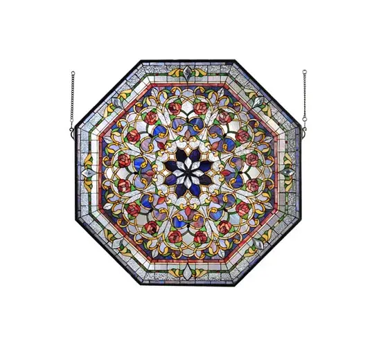 A magnificent octagon shaped stained glass window features various symmetric design repeats that branch out from a Cobalt and Clear Beveled glass eight-petaled flower in the central medallion. Victorian styled floral motifs with Red Roses blossom from natural Green and Golden stems among fanciful Beige scrollwork on backgrounds of Cobalt; Clear Iridescent and Clear Ripple glass. The design is trimmed with tilework borders in Dusty Rose; Leafy Greens and Rosy Reds and Cobalt on a Clear Ripple and Clear Iridescent glass trim with Lavender and Red jewels. The window features an Antique Brassfinished frame and includes hanging chains.