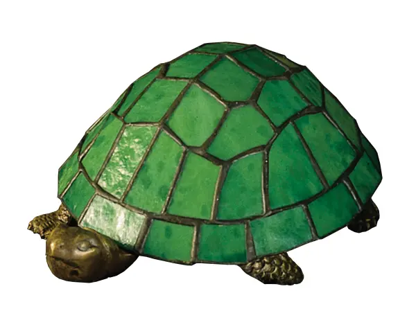 A Land Turtle is transformed into a charming accent lamp featuring a mottled Green stained glass shade resting on a cast metal base. Collection: Turtle Finish: Mahogany Bronze Glass: Green Art Glass Width: 6.00" Height: 4.00" Length: 9.00" Weight: 2.00 lb Extension from Wall: 6.00" Number of Bulbs: 1 Maximum Wattage: 15.00 W Bulb Type: B10 Bulb Base: E12 Material: Metal Or Polyresin Country of Origin: CHINA Safety Listing: Dry Safety Rating: Dry