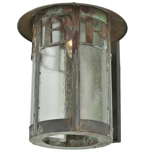 This cylindrical-shaped wall sconce is personalized with monograms featured in a handsome Vintage Copper finish. Soft ambient light is diffused beautifully through the Clear Seeded Glass lens. The fixture is perfect for installation on interior walls in hallways and entryways. The Personalized RC/EC Solid Mount Wall Sconce is included in our American-made; American-designed; handcrafted Personalized Collection and manufactured in Yorkville; New York. The fixture is UL and cUL listed for dry and damp locations. This lighting fixture can be ordered by calling us and adding your own business name/logo or family name for your next project. Please call for pricing and lead time. - alternate view