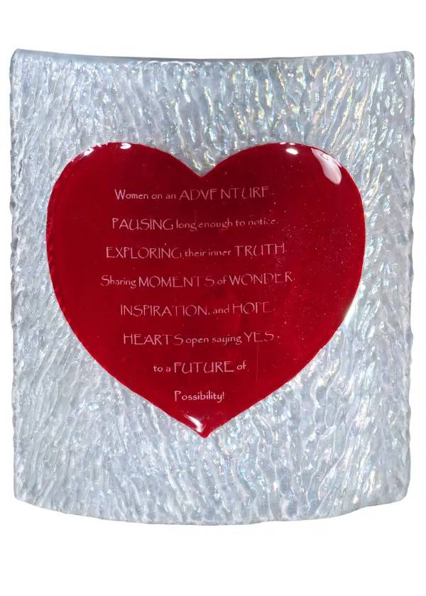 This stunning Kiln-Fused glass panel features wonderfully poetic phrases about Women on an Adventure" in White on an alluring Red heart-shaped glass profile. This lovely Heart-shaped; jewel-like figure is featured on a Clear Ripple Glass background. The Personalized Heart Panel is included in our American-made; American-designed; handcrafted Personalized Fused Glass Collection and manufactured in Yorkville; New York. Our Fused Glass Collection is the result of our long-standing expertise in hot glass fabrication techniques; which we have mastered in our Quality Bent Glass division. Traditional workmanship; high fire kilns; and original tools are used to slump and fuse glass in the old-world tradition. Pendants; sconces; and other fixtures are offered in unique glass textures and stunning color/design combinations. Please contact us and we will coordinate your favorite poem; quote; or anecdote to create a custom art glass panel to suit your next project. Please call for the price and lead time."