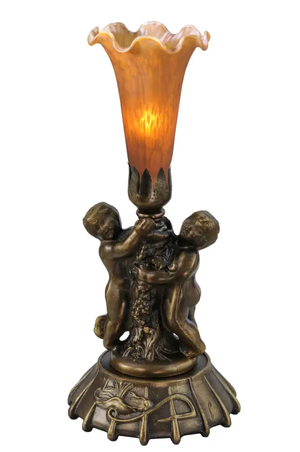 Inspired by the famous Tiffany design from the early 1900s.... This mini lamp features a stunning Amber art glass shade that is embraced by an elegant cast base featuring two cherubs finished by hand in Mahogany Bronze. The Pond Lily Twin Cherub Mini Lamp is featured in our American designed, handcrafted Favrile Glass Lighting Collection. UL and cUL listed for dry locations. Each shade is a unique work of art with color variations based on natural ingredients inherent in the glass. Contact us if color matching is critical when ordering multiple items. Collection: Amber Finish: Mahogany Bronze Glass: Amber Width: 5.00" Height: 12.00" Length: 5.00" Weight: 3.00 lb Number of Bulbs: 1 Maximum Wattage: 40.00 W Bulb Type: B10 Bulb Base: E12 Light Source: CFL Material: Zinc Country of Origin: CHINA Safety Listing: Dry Safety Rating: Dry
