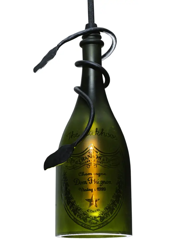 Connoisseurs will appreciate the detail and flavor of this mini pendant featuring a customer-supplied Dom Perignon Champagne Bottle. Delicate hand-wrapped; vine-like metal accents are offered in a Bold Black finish to enhance this Green bottle. Liven up a restaurant; club; or home with a light fixture that does so much more than deliver light; it adds personality and pizzazz. The overall height ranges from 22 to 72 inches; as the Black cord can be adjusted on location to meet your exact lighting requirements. This rich-looking Personalized Champagne Bottle Mini Pendant is included in our American-made; American-designed; handcrafted Potent Potable Bottle Lighting Collection. The fixture is manufactured in Yorkville; New York. UL and cUL listed for dry and damp locations. Take your finest bottle of champagne or wine; and Meyda will transform it into an everlasting personalized fixture of light. Contact us for more information on custom wine and liquor bottle lighting fixtures and lamps. You can also create custom lighting with beer/whiskey bottles; mason jars; milk bottles; and other glass containers and vessels by contacting us!