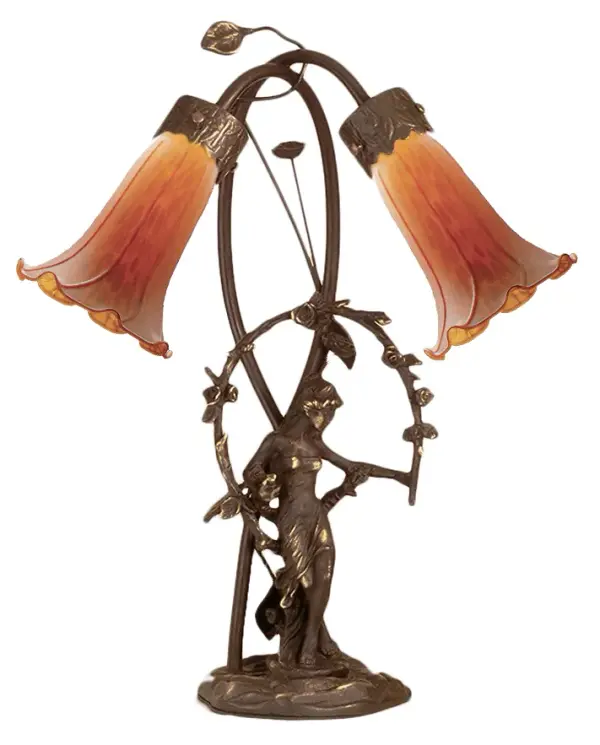 Inspired by Tiffany's famous Pond Lily design from the early 1900s... This table lamp is created with two mouth blown shades featuring Amber art glass. The Pond Lily shades are embraced by an elegant Cast Bronze Base featuring a girl under a trellis and finished in a rich Mahogany patina. The Pond Lily Table Lamp is included in our American designed, handcrafted Favrile Lighting Collection. UL and cUL listed for dry locations. Each shade is a unique work of art with color variations based on natural ingredients inherent in the glass. Contact us if color matching is critical when ordering multiple items. Collection: Amber Finish: Mahogany Bronze Glass: Amber Width: 15.00" Height: 17.00" Length: 15.00" Weight: 8.00 lb Number of Bulbs: 2 Maximum Wattage: 15.00 W Bulb Type: B10 Bulb Base: E12 Material: Bronze Country of Origin: CHINA Safety Listing: Dry Safety Rating: Dry