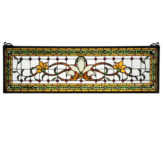 Herald in a touch of class to your home with this stylized floral stained glass window that features beautiful vivid colors in a simplistic design. At the focal point of this window is a Bone Beige flower flanked by Saffron flowers on each side. Mahogany stems and green leaves wed the floral design on a clear back ground accented with red jewels. A Green chain link design accented with Beige diamonds and Red jewels is surrounded by saffron to complete the design. This stunning window is created using the famous Meyda Tiffany copper foil construction process and attached to a Black frame. This transom window can be used above a door or placed as a pair on both sides of a door; especially in entryways. Brackets and hanging chains are included.