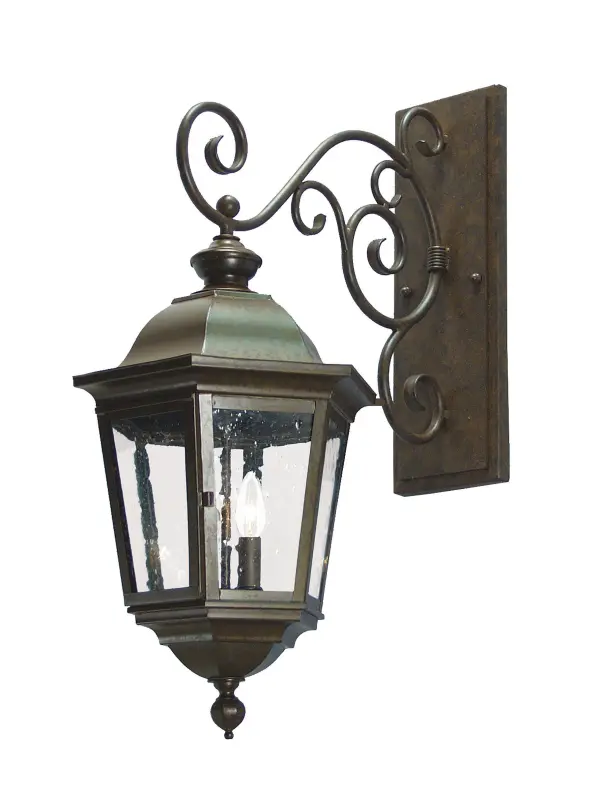 Luxurious elegance and distinctive sophistication are combined to create the Cassandra Wall Sconce. An elegant scrolled arm and classic shade profile feature Clear Seeded Glass that reveals two faux candlelights. The hardware and frame are featured in an Antique Rust finish. Custom crafted in our manufacturing facility in Upstate New York; this interior/exterior wall fixture is available in custom styles; sizes and finishes. Dimmable energy efficient lamps such as LED are also available. The 28-inch tall sconce is UL and cUL listed for dry; damp and wet locations.