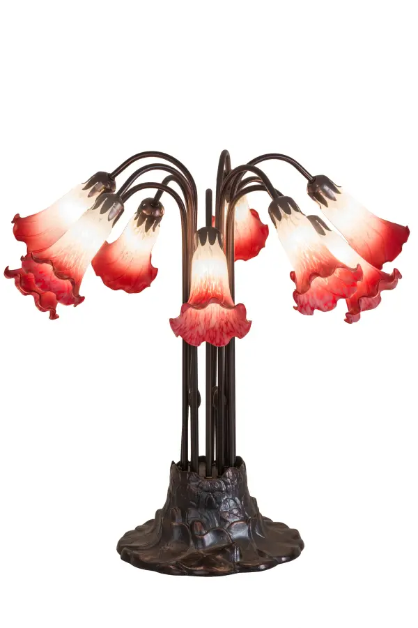 One of the most popular Louis Comfort Tiffany styled lamps on the market today; recreating his famous Favrile design from the early 1900's. This softly mottled Petal Pink shaded Ten Light Table Lamp offers an attractive; delicate design featuring shades mouth blown of fine art glass. Lily shades are suspended from stems delicately winding above a Lily pad base finished by hand in Mahogany Bronze.