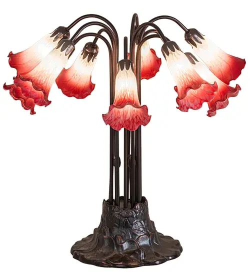 One of the most popular Louis Comfort Tiffany styled lamps on the market today; recreating his famous Favrile design from the early 1900's. This softly mottled Petal Pink shaded Ten Light Table Lamp offers an attractive; delicate design featuring shades mouth blown of fine art glass. Lily shades are suspended from stems delicately winding above a Lily pad base finished by hand in Mahogany Bronze. - alternate view