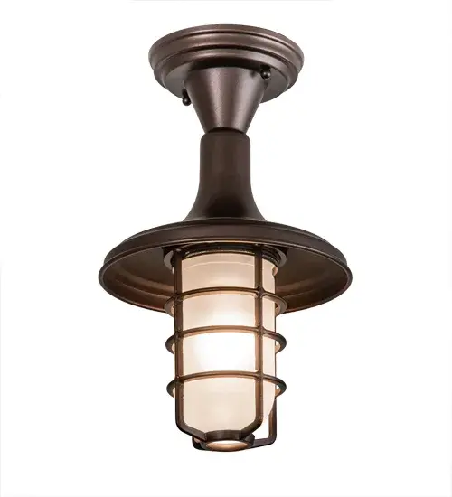 An industrial styled single light fixture with lamp guard is designed for residential and restaurant applications. The hardware are hand finished in a handsome Mahogany Bronze and the shade is crafted of Sandblasted Frosted Clear glass. Custom sizes; styles and colors available. The fixture is handcrafted by Meyda artisans at the company's manufacturing facilities in Upstate New York - alternate view