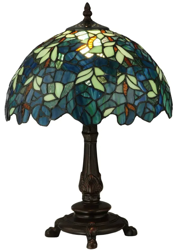 Capture the tranquility of a garden stroll at nightfall with this Nightfall Wisteria accent lamp by Meyda Tiffany. Imagine wandering under darkening skies; past the deepening blooms and climbing vines of the wisteria shrubbery; as you prepare for a restful night of welcome slumber. This beautiful accent lamp; created with blue; blue/green and green art glass using the copperfoil construction process made famous by Louis C. Tiffany in the early 20th century is a masterpiece to be proudly displayed and privately enjoyed in any home or interior setting.