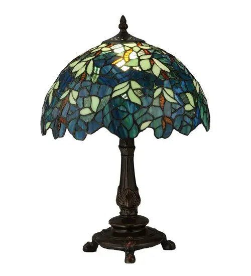 Capture the tranquility of a garden stroll at nightfall with this Nightfall Wisteria accent lamp by Meyda Tiffany. Imagine wandering under darkening skies; past the deepening blooms and climbing vines of the wisteria shrubbery; as you prepare for a restful night of welcome slumber. This beautiful accent lamp; created with blue; blue/green and green art glass using the copperfoil construction process made famous by Louis C. Tiffany in the early 20th century is a masterpiece to be proudly displayed and privately enjoyed in any home or interior setting. - alternate view