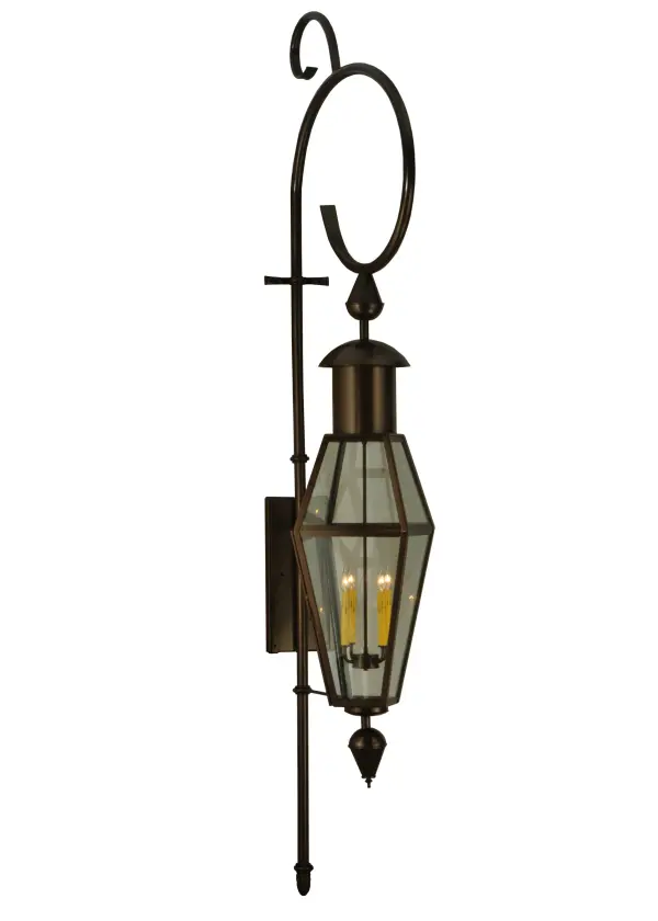 A towering indoor/outdoor wall lantern. This sconce combines traditional elegance with gothic charm. A Clear Glass Lens reveals four Ivory faux candlelights. The fixture is complemented with a Hand-Forged Iron Scrolled element featured in a Timeless Bronze finish. Handcrafted by highly skilled artisans in our 180;000 square foot manufacturing facility in Yorkville; New York. Lantern styles; metal finishes and fixture sizes can be customized to your needs. UL and cUL listed for dry; damp and wet locations.