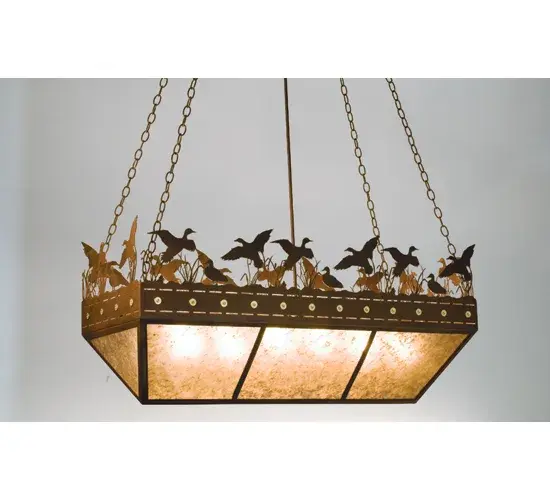 A flock of Ducks in and above cattails and marsh grasses top this wildlife inspired original oblong inverted pendant handcrafted in the USA by Meyda artisans. Suspended from chain links the bullet accented band and Ducks top Silver mica panels. This fixture has a Rust finish. Collection: Ducks In Flight Finish: Rust Glass: Silver Mica Width: 18.00" Height: 27.00" Length: 48.00" Weight: 35.00 lb Extension from Wall: 18.00" Number of Bulbs: 6 Maximum Wattage: 60.00 W Bulb Type: A19 Bulb Base: E26 Material: Steel Country of Origin: USA Safety Listing: Dry Safety Rating: Damp