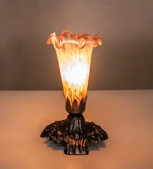 One of the most popular Louis Comfort Tiffany style designs... This Pond Lily mini lamp offers an attractive; delicate design featuring a mouth blown shade created with Amber and Purple art glass. The shade is seated in an elegant base finished by hand in Mahogany Bronze. The Pond Lily Mini Lamp is featured in our American designed; handcrafted Favrile Glass Lighting Collection. UL and cUL listed for dry locations. Each shade is a unique work of art with color variations based on natural ingredients inherent in the glass. Contact us if color matching is critical when ordering multiple items.