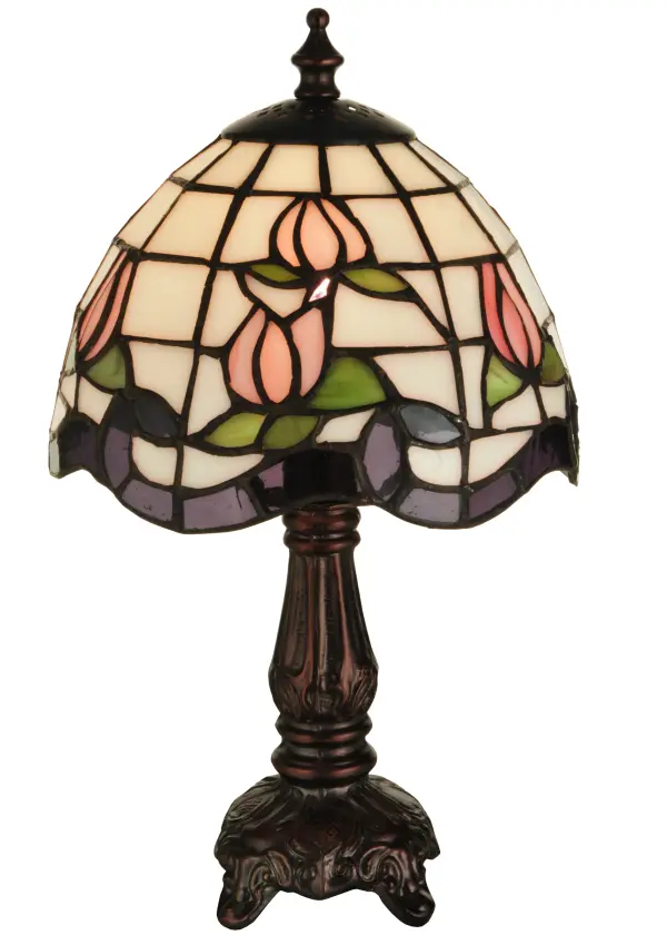 Grace your home with the elegant Roseborder Mini Lamp. This lamp features an exquisitely crowned shade revealing a gridwork of Beige art glass adorned with a Plum Waterglass border of swirling ribbons and perfect Pink Rosebuds with Green Leaf accents. The art glass shade is created using the famous Meyda Tiffany copper foil construction and embraced by an elegant cast metal base finished in Mahogany Bronze. The Roseborder Table Lamp is included in our American designed, handcrafted Stained Glass Lighting Collection. UL and cUL listed for dry locations.? Each shade is a unique work of art with color variations based on natural ingredients inherent in the glass. Contact us if color matching is critical when ordering multiple items. Collection: Roseborder Finish: Mahogany Bronze Glass: Ca Ja Pac (Purple Waterglass) Width: 7.00" Height: 12.00" Length: 7.00" Weight: 2.00 lb Number of Bulbs: 1 Maximum Wattage: 25.00 W Bulb Type: B10 Bulb Base: E12 Material: Zinc Country of Origin: CHINA Safety Listing: Dry Safety Rating: Dry
