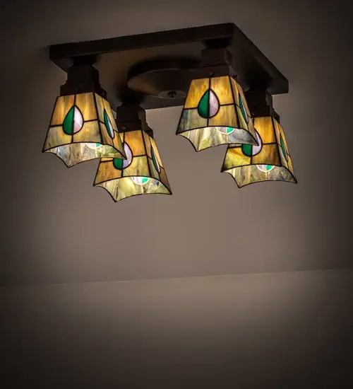 The Mackintosh Leaf stained glass flushmount features four Tiffany style shades in a striking leaf design of Purple; Highland Teal and Peacock Feather Green glass on a Heather glass background. The ceiling fixture was inspired by a famous design from Scottish Nouveau Artist Charles Rennie Mackintosh and is enhanced with a Mahogany Bronze finish. The shades are created using the famous Meyda Tiffany copperfoil construction process. UL and cUL listed for dry and damp locations.