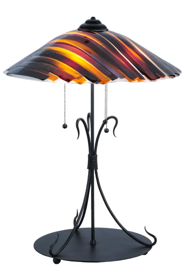 This contemporary Metro Fusion dome-shaped shade is an original design that is far from the traditional. This unique shade is handmade in our Marina pattern of Amber; Smoke Iridescent; Purple and Clear colored; kiln-fired; fused art glass; and paired with a unique triple-hook base featured in a Mahogany Bronze finish. It is perfect for a beautiful display in picture windows; dining areas; and living spaces in fine homes and hotels from Shelter Island; New York; to Columbus; Ohio; to Palm Springs; California. The Metro Fusion Marina Glass Table Lamp is included in our American-made; American-designed; handcrafted Fused Glass Collection; which is manufactured in Yorkville; New York. UL and cUL listed for dry locations. Each shade is a unique work of art with color variations based on natural ingredients inherent in the glass. The Quality Bent Glass division of Meyda Tiffany Lighting is over 100 years in the making. Today; we are still creating timeless masterpieces using tools and methods from the days when we supplied Tiffany Studios. Fused glass colors and metal finishes are customizable; as each fixture is handcrafted to order.