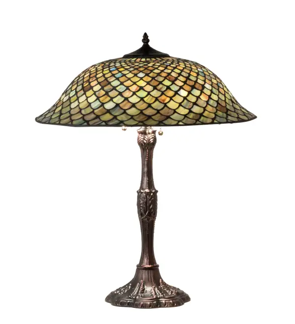 A Tiffany Studios classic. The Fishscale pattern is reproduced in variegated glass of Honey dripped Emerald; Sapphire; Amber and Mauve; evoking a unique dimensional and textured look in a rainbow of brilliant hues. This exquisite art glass shade is complemented with a Mahogany Bronze hand finished lamp base. This exquisite variegated art glass shade is created using the famous Meyda Tiffany copperfoil construction process. UL and cUL listed for dry locations. Each shade is a unique work of art with color variations based on natural ingredients inherent in the glass. Contact us if color matching is critical when ordering multiple items.