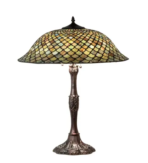A Tiffany Studios classic. The Fishscale pattern is reproduced in variegated glass of Honey dripped Emerald; Sapphire; Amber and Mauve; evoking a unique dimensional and textured look in a rainbow of brilliant hues. This exquisite art glass shade is complemented with a Mahogany Bronze hand finished lamp base. This exquisite variegated art glass shade is created using the famous Meyda Tiffany copperfoil construction process. UL and cUL listed for dry locations. Each shade is a unique work of art with color variations based on natural ingredients inherent in the glass. Contact us if color matching is critical when ordering multiple items. - alternate view