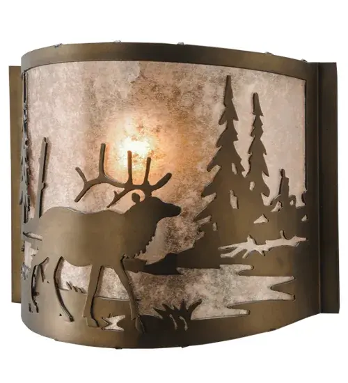 Rustic charm is captured beautifully with this majestic Elk meandering near a woodland lake while the morning sun rises in the background of this natural wildlife inspired sconce. Soft ambient light projects through a stunning Silver Mica lens which is complemented with an Antique Copper finish. This curvaceous wall sconce is handcrafted by highly skilled artisans in our 180;000 square foot manufacturing facility in Yorkville; NY. Diffuser colors; metal finishes and fixture sizes can be customized to your needs. UL and cUL listed for dry and damp locations. - alternate view