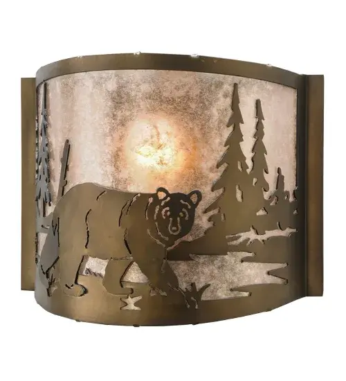 The call of the wild comes to light with a majestic Bear roaming around the woodland lake. Beautiful ambient light shines through the Silver Mica lens while the fixture is enhanced with accents and hardware featured in an Antique Copper finish. The ADA-compliant wall sconce can be installed in dining rooms and entryways in residential, hospitality, and commercial spaces. The Bear at Lake Wall Sconce is featured in our American-made, American-designed, handcrafted Wildlife Lighting Collection. This fixture is manufactured in Yorkville, New York. It is UL and cUL listed for dry and damp locations. Upstate New York's adventurous playland, known as the Adirondack Mountains, with its many breathtaking forests, lakes, and rivers, is the spiritual birthplace of Meyda and inspires our rustic-themed mica collections. Collection: Northwoods Bear At Lake Finish: Antique Copper Glass: Silver Mica Width: 12.00" Height: 9.50" Length: 4.00" Weight: 2.50 lb Extension from Wall: 4.00" Number of Bulbs: 1 Maximum Wattage: 60.00 W Bulb Type: A19 Bulb Base: E26 Material: Steel Country of Origin: USA Safety Listing: Damp Safety Rating: Damp - alternate view