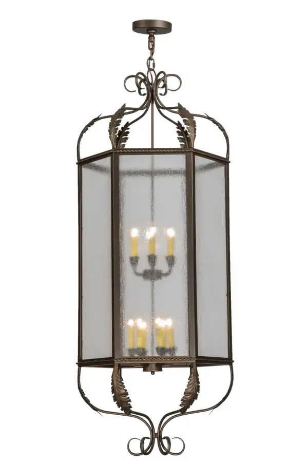 Utilizing a blend of timeless craftsmanship and classic design, the Celida Pendant brings home unsurpassed quality and shapely appeal. Evoking a dramatic effect, ambient light is evoked through Rainstone Idalight which reveals two faux 6-light candelabras featured within this pendant. The fixture is enhanced with gracefully designed acanthus leaf and scroll accents, hardware and frame featured in a Tyler Bronze finish. The fixture is handcrafted by highly skilled artisans in our factory in Yorkville, New York. Custom options include various sizes, colors, designs and dimmable energy efficient lamping options such as LED. This pendant is UL and cUL listed for damp and dry locations. Collection: Calida Finish: Tyler Bronze Glass: Rainstone Idalight Width: 24.00" Height: 66.00" Length: 24.00" Weight: 45.00 lb Number of Bulbs: 12 Maximum Wattage: 60.00 W Bulb Type: BA9 Bulb Base: Candelabra Material: Steel Country of Origin: USA Safety Listing: Damp Safety Rating: Damp