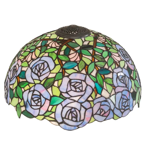 One of the most beloved of all floral beauties. The Rosebush is beautifully represented in this stunning lighting shade design that features beautiful Lavender art glass Roses ramble on a maze of Garden Green leaves with Bark Brown branches. This gorgeous shade is created using the famous Meyda Tiffany copperfoil construction. The delicate stained glass shade can be paired with a base to create a striking table or floor lamp and matched with hardware to build a beautiful wall or ceiling fixture. This design is inspired by the lovely Rose Gardens from Brooklyn; New York; to Pasadena; California. The Rosebush Shade is included in our American designed; handcrafted Tiffany Reproduction Collection. Each shade is a unique work of art with color variations based on natural ingredients inherent in the glass. Please contact us if color matching is critical when ordering multiple items.