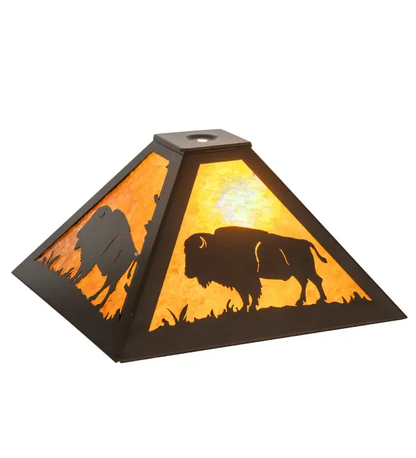 The majestic Buffalo stands in all its glory on the prairie as the early morning sun rises; casting a brilliant glow in the background. The shade features an Amber Mica shade and is complemented with a frame and decorative accents featured in a Timeless Bronze finish. The shade pairs well with a base to create a table lamp and can be matched with hardware to build a ceiling pendant. The Buffalo Shade is included in our American-made; American-designed; handcrafted Wildlife Lighting Collection. This fixture is manufactured in Yorkville; New York.