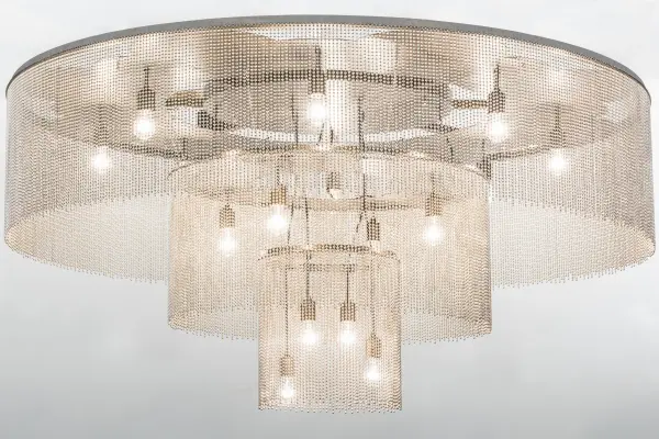Like the gentle flow of a water fountain with tiny droplets dancing in mid-air, you can almost hear the pitter-patter as it creates soft ripples in the imaginary pool below. Beautiful ambient light evokes from 16 Customer supplied, Medium base bulbs embraced from three tiers of this lovely ceiling fixture. A Nickel finished veil is enhanced with a canopy featured in an Extreme Chrome finish. Handcrafted in the USA, this flushmount is available in custom designs, sizes and finishes, as well as dimmable energy efficient lamping options. The stunning fixture is UL and cUL listed for damp and dry locations. Collection: Niagara Finish: Extreme Chrome Glass: Amber,Black Width: 72.00" Height: 36.00" Length: 72.00" Weight: 195.00 lb Number of Bulbs: 16 Maximum Wattage: 60.00 W Bulb Type: A19 Bulb Base: E26 Material: Steel Country of Origin: USA Safety Listing: Damp Safety Rating: Damp