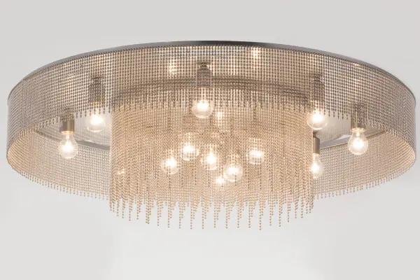 Like a hard rain beginning to fall; this dynamic chandelier illuminates beautifully; replicating a brilliant sun shower with a modern industrial twist. The 13 Edison-style lamps illuminate inner and outer Nickel-plated Ball Chain garlands complemented with Extreme Chrome and Mercury finishes. This ceiling fixture serves as a centerpiece for dining and living areas in residential; retail; office; and hospitality spaces. The Ball Chain Chandelier is featured in our American-made; American-designed; handcrafted Industrial Lighting Collection. This fixture is manufactured in Yorkville; New York. UL and cUL listed for dry and damp locations. This fixture is featured in Stony Creek Hotels of the Embergrove Hospitality Group.