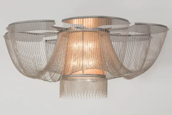 Like the gentle flow of a water fountain with tiny droplets dancing in mid-air; you can almost hear the pitter-patter as it creates soft ripples in the imaginary pool below. Beautiful ambient light evokes from a tapered Silver Mica shade which is complemented with a Statuario Idalight bottom diffuser and Nickel finished hardware. Handcrafted in the USA; this flushmount is available in custom designs; sizes and finishes; as well as dimmable energy efficient lamping options. The fixture is UL and cUL listed for damp and dry locations.