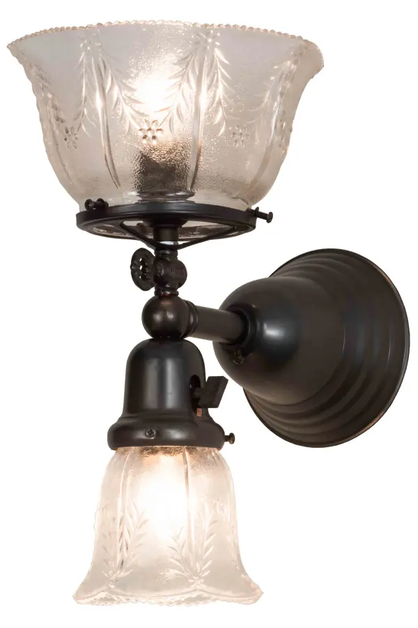 Step back in time with a traditional glass; fit and finish. This fixture is reminiscent of lighting from the early 1900s when people were transitioning from gas lamps to electric. The Clear Textured Revival glass shades offer an authentic historic look to complement any room or space. The larger glass goblet styled shade provides indirect light upwards and recreates a gas powered fixture; while the smaller goblet shade delivers down lighting and re-creates early electric fixtures back in the day. Craftsman Brown finished hardware and authentically detailed accents make this piece a timeless treasure. This fixture is handcrafted by Meyda artisans in Yorkville; NY.