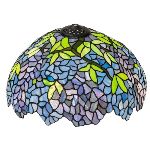 Stylized Wisteria flower clusters of Petal Pink; Mauve and Pastel Blue with Jade Green leaves drape over this Beige toned shade. The classic styling of this Tiffany inspired art glass and soft pastel colors will add charm to any room. This art glass shade is created using the famous Meyda Tiffany copper foil construction. Shade pairs well with a table and floor lamp bases; or matches with hardware to create a ceiling or wall fixture. The Wisteria Shade is included in our American-designed; handcrafted Tiffany Reproduction Collection. Each shade is a unique work of art with color variations based on natural ingredients inherent in the glass. Contact us if color matching is critical. - alternate view