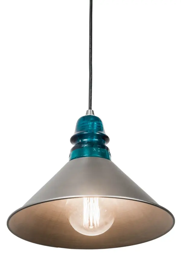 Muncie combines classic utilitarian design with a timeless look. The Industrial Steel finished shade reveals a single customer-supplied Edison lamp for illumination as a pendant for a kitchen, foyer, lounge and other residential and commercial settings. Adorning the top of the shade is a Peacock Blue insulator evoking memories of a bygone era. Custom crafted in Upstate New York by our expert artisans, this pendant is available in custom sizes, styles and colors. Dimmable energy efficient lamping options such as LED are available. This fixture is UL and cUL listed for damp and dry locations. Collection: Muncie Finish: Industrial Steel Glass: Blue Width: 12.00" Height: 11.00" Length: 12.00" Weight: 2.50 lb Extension from Wall: 3.50" Number of Bulbs: 1 Maximum Wattage: 60.00 W Bulb Type: G30 Bulb Base: E26 Material: Metal Or Polyresin Country of Origin: USA Safety Listing: Damp Safety Rating: Damp
