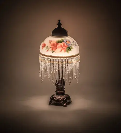 A charming nostalgic mini lamp. This Roussillon Lamp features a stunning White Glass shade with a Rose Bouquet fused image that is color coordinated with delicate White and Pink glass beaded fringe. This Victorian-inspired; intricately detailed shade is combined with a beautifully detailed cast metal footed lamp base in a Mahogany Bronze finish. The Roussillon Rose Bouquet Fringed Mini Lamp is included in our American designed; handcrafted Victorian Collection. UL and cUL listed for dry locations.