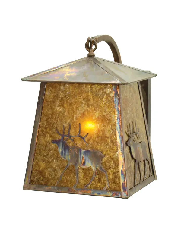 A North Woods Elk is depicted on this handsome American Craftsman lantern style curved arm wall sconce. The fixture; handcrafted in the USA by Meyda artisans; is finished in Vintage Copper and has Amber mica panels.