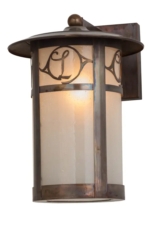 Custom crafted of Solid Copper for interior and exterior lighting applications. This solid mount wall sconce is personalized with the monogram of the client in a Vintage Copper finish that complements the Frosted Seeded Glass shade. The Fulton cylindrical shaped fixture is Domestically Produced in our 180;000 sq ft manufacturing facility in Yorkville; NY. The Build Your Own lighting series offers fully configurable combinations of lantern styles; functions; fixture sizes and metal finishes to meet your lighting needs. UL and cUL listed for dry; damp and wet locations. Personalized items are shown as examples of our craftsmanship. They are not for sale as is but can be customized to fit your personal needs.