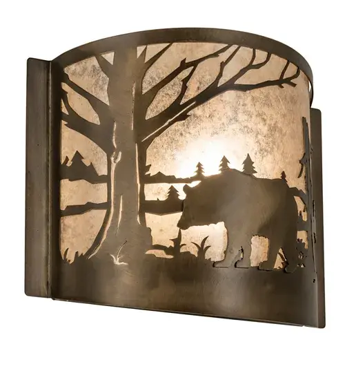 Drawing inspiration from the wildlife and natural beauty in the nearby Adirondack Mountains. A Majestic Bear wanders near this woodland lake while surrounded by Pine Tree silhouettes. The curvaceous shade features a Silver Mica lens complemented with an Antique Copper finish. Ideal for illuminating hallways and dining areas in residential and hospitality settings, from Rockland, Maine, to Eden Prairie, Minnesota, to Eugene, Oregon. The Bear at Lake Wall Sconce is ADA Compliant and featured in our American-made, American-designed, handcrafted Wildlife Lighting Collection. Manufactured in Yorkville, New York. UL and cUL listed for dry and damp locations. Collection: Bear At Lake Finish: Antique Copper Glass: Silver Mica Width: 12.00" Height: 9.50" Length: 4.00" Weight: 9.00 lb Extension from Wall: 4.00" Number of Bulbs: 1 Maximum Wattage: 60.00 W Bulb Type: A19 Bulb Base: E26 Material: Steel Country of Origin: USA Safety Listing: Damp Safety Rating: Damp - alternate view