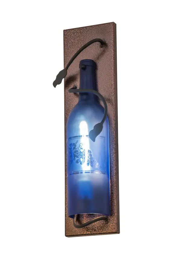 Capture the mood or life of any party with authentic wine bottle lighting. This wall fixture does so much more than deliver light, it adds personality and pizazz to any interior. A hand forged Black vine and leaf coil is designed around the neck of this stunning Blue Glass wine bottle, which illuminates and features a stunning etched Grape design. The sconce is complemented with handsome hardware featured in a Copper Vein finish. Perfect for homes, restaurants, hotels, pubs, nightclubs, wineries, and retailers, this sconce is handmade by Meyda artisans in our manufacturing facilities in upstate New York. Custom colors, styles, sizes and dimmable energy efficient lamping options. UL and cUL listed for damp and dry locations. Collection: Tuscan Vineyard Finish: Copper Metallic / Black Cherry Glass: Blue Sandblasted Width: 4.50" Height: 15.00" Length: 2.50" Weight: 2.00 lb Extension from Wall: 2.50" Number of Bulbs: 1 Maximum Wattage: 40.00 W Bulb Type: T6.5 Bulb Base: E17 Material: Metal Country of Origin: USA Safety Listing: Damp Safety Rating: Damp