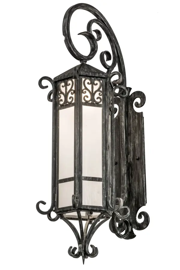 Grand stature and an ornate Hand-forged Iron Metalwork create a rich luxurious look for Caprice. This high-styled wall fixture features Frosted Seeded glass, enhanced with scrolled accents and hardware offered in an Antique Iron Gate finish. This sconce complements various architectural styles for today's exteriors and interiors. The Caprice Lantern Wall Sconce is included in our American-made, American-designed, handmade Traditional Lighting Collection and manufactured in Yorkville, New York. UL and cUL listed for dry, damp and wet locations, however, the steel hardware might not be suitable for coastal or harsh exposed environments. Contact us if you want options for a more durable hardware material to suit your site criteria. Collection: Caprice Finish: Antique Iron Gate Glass: Frosted Seeded Glass Width: 12.00" Height: 37.00" Length: 16.00" Weight: 34.00 lb Extension from Wall: 16.00" Number of Bulbs: 1 Maximum Wattage: 60.00 W Bulb Type: A19 Bulb Base: E26 Material: Steel Country of Origin: USA Safety Listing: Damp Safety Rating: Wet