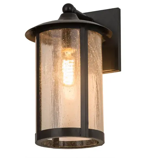 Handcrafted from Solid Brass with alluring rustic beauty. This stunning Craftsman Signature lantern features a Clear Seeded Glass lens enhanced with a Craftsman Brown finish. Display this wall sconce to illuminate the exterior of timber homes, modern farmhouses, and other spaces. The Fulton Prime Solid Mount Wall Sconce is included in our American-made, American-designed, handcrafted Craftsman Signature Series, manufactured in Yorkville, New York. UL and cUL listed for dry, damp, and wet locations. Our Build Your Own Craftsman Signature Series features unlimited combinations of styles. The collection is called Build Your Own because it is fully configurable and customizable from size and design to finish and lens color. Marine grade, solid brass, or copper raw materials are utilized to ensure items from the Craftsman Signature Series of outdoor and indoor lighting will stand the test of time, as these premium metals are impervious to most types of oxidation. Hand-applied Patina finishes on brass and copper are sealed with a clear varnish and over time, may require gentle maintenance, such as wax, to delay or reverse the natural living finish attributes indicative of this finishing process. Patina finishes on brass and copper provide strong resistance to fading from sun exposure, will not chip or crack, and will not rust like a steel-framed item in the same conditions. Choose from many style options, or send us your concept today! Call today to learn how to use the configuration tool available on our website for an instant item number! Collection: Fulton Finish: Craftsman Brown Glass: Clear Seeded Glass Width: 8.00" Height: 13.00" Length: 8.50" Weight: 4.50 lb Extension from Wall: 8.50" Number of Bulbs: 2 Maximum Wattage: 60.00 W Bulb Type: A19 Bulb Base: Medium Material: Brass Country of Origin: USA Safety Listing: Wet Safety Rating: Wet - alternate view