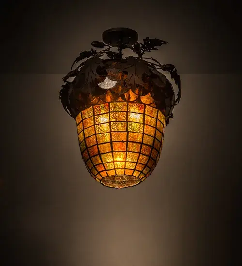 Nature inspired lighting is combined with functional versatility. This Acorn art glass shade in Autumn Multi-tones with Bark Brown granite glass sprouts Oak Leaf and Acorn accents in Mahogany Bronze. Customized adjustable hardware enables shade to swivel & lock to direct lighting wherever needed. Concealed behind the art glass are 2 customer supplied medium base lamps that provide ambient illumination while 1 customer supplied spot delivers accent lighting. Ideal for highlighting wall decor or illuminating surfaces such as countertops and work areas. Shade is created using famous Meyda Tiffany copperfoil construction. Hardware is custom crafted in our 180;000 sq ft manufacturing facility in Yorkville; NY. UL & cUL for damp & dry locations.