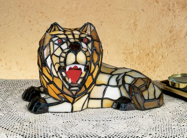 7"H Tiffany Lion Accent Lamp?The roar of the Lion pales in comparison to its regal charm and stained glass beauty. ?With eyes and tongue in matching Regal Red, this Honey and Beige colored glass animal sits on the thrown of his kingdom. ?? Crafted using Tiffany's famous copperfoil construction method. Collection: Tiffany Lion Finish: Ha Amber Flame Glass: Ha Xa Fl Width: 11.50" Height: 7.00" Length: 6.50" Extension from Wall: 6.50" Number of Bulbs: 1 Maximum Wattage: 15.00 W Bulb Type: B10 Bulb Base: E12 Country of Origin: CHINA Safety Listing: Dry Safety Rating: Dry